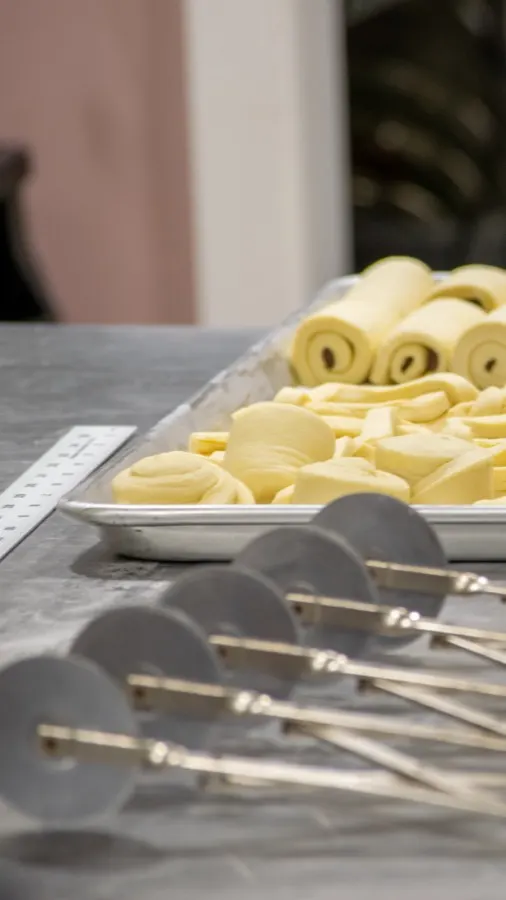 Croissant dough being laminated by hand