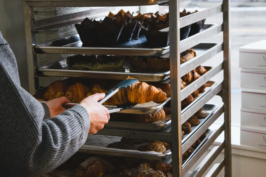 Fresh pastries coming out of the oven on a rack